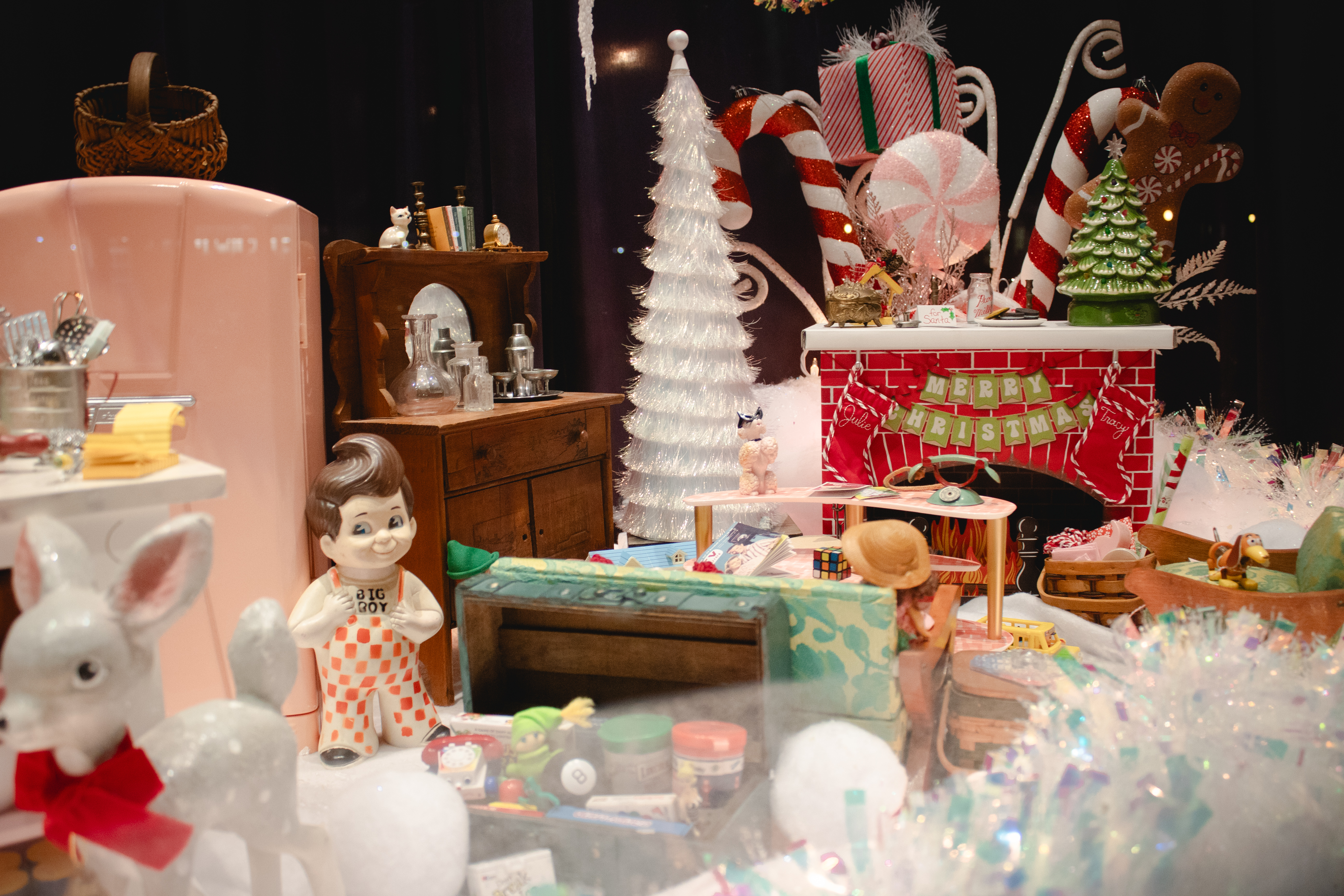 1950s Christmas window display at the Mathews Museum with vintage toys and a tinsel tree